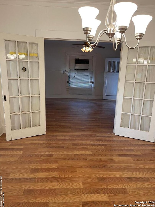 unfurnished dining area with dark wood-type flooring and a notable chandelier