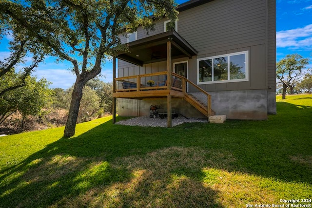 rear view of house featuring a yard