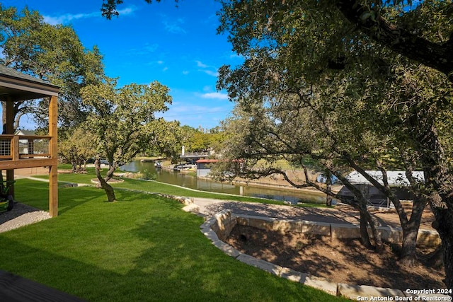 view of community featuring a yard and a water view