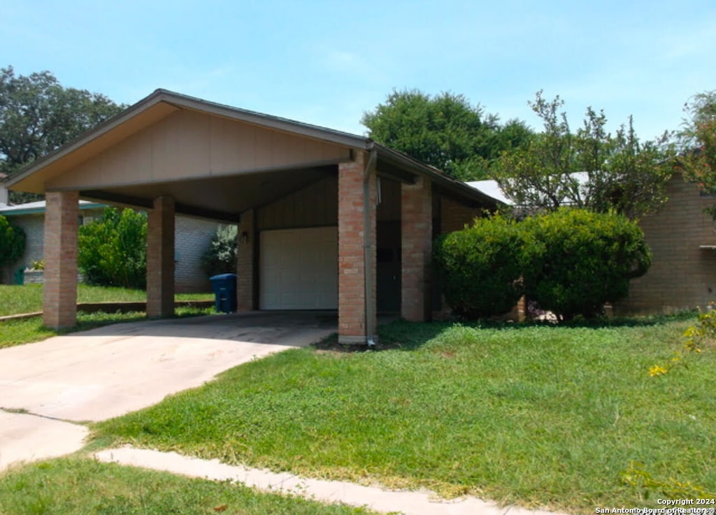 view of home's exterior featuring a lawn and a garage