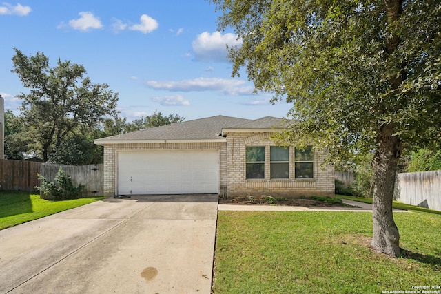 ranch-style home with a garage and a front lawn