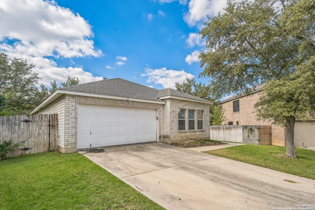 view of front of house featuring a front lawn and a garage