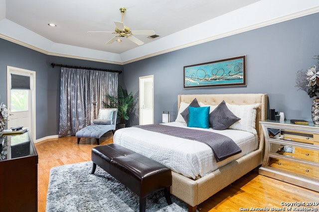 bedroom featuring hardwood / wood-style floors and ceiling fan