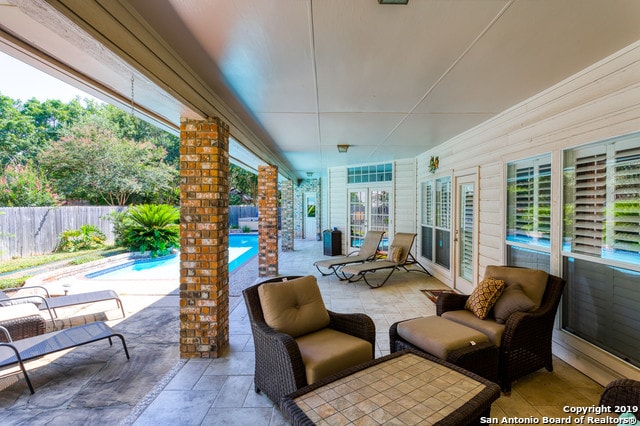 view of patio / terrace with an outdoor living space and a fenced in pool