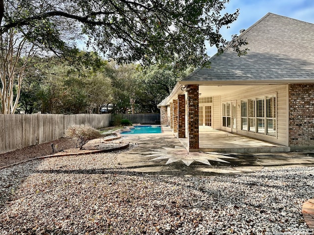 view of yard with a fenced in pool and a patio area