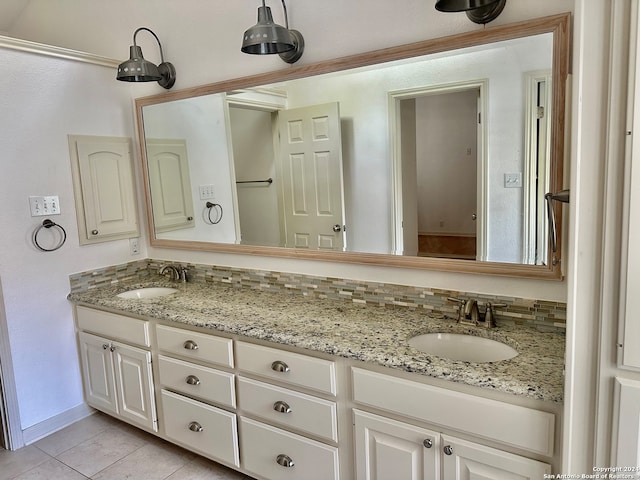 bathroom featuring tasteful backsplash, tile patterned floors, and vanity