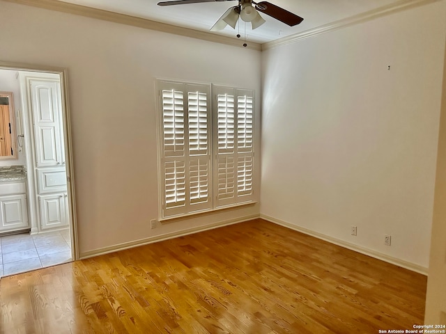 empty room featuring ceiling fan, ornamental molding, and light hardwood / wood-style flooring