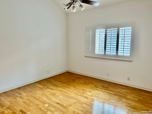 unfurnished room featuring ceiling fan, lofted ceiling, and light hardwood / wood-style flooring