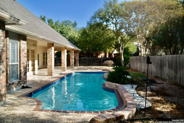 view of swimming pool featuring a patio area