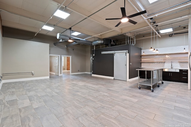 garage featuring ceiling fan and sink