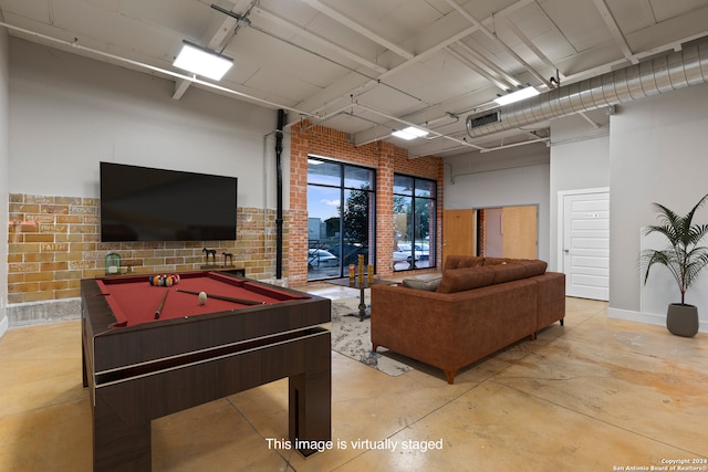 game room featuring brick wall and pool table