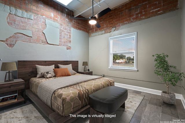 bedroom with brick wall and ceiling fan