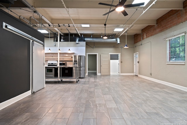 interior space featuring brick wall, stainless steel fridge, and ceiling fan