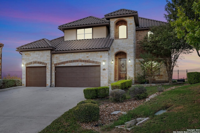 mediterranean / spanish house featuring a garage