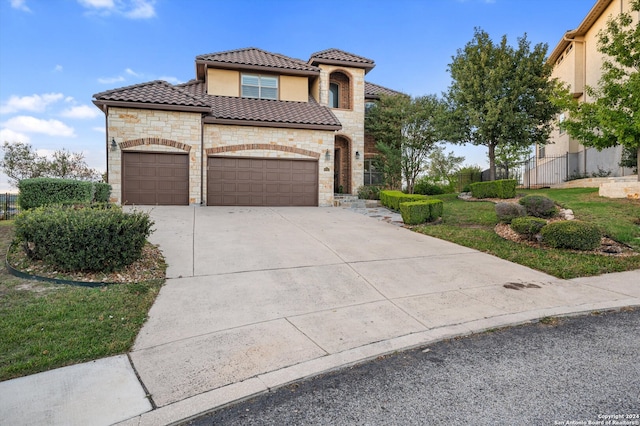 mediterranean / spanish-style house with a garage