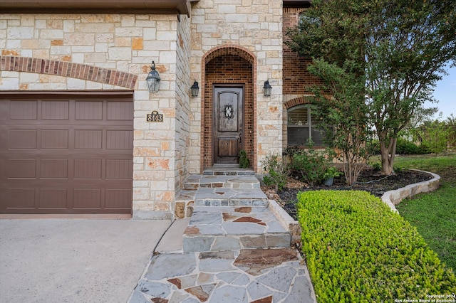 view of exterior entry featuring a garage