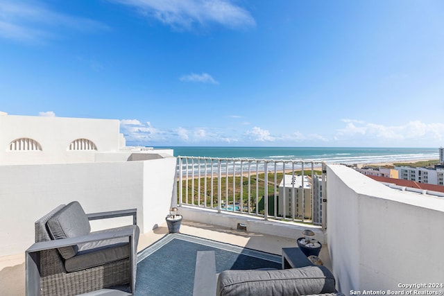 balcony featuring a water view and a beach view