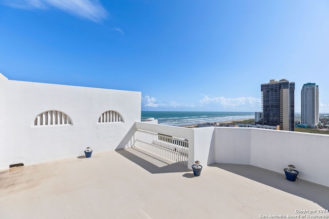 view of patio with a view of the beach and a water view