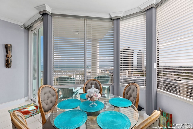 dining area with light tile patterned floors and ornamental molding