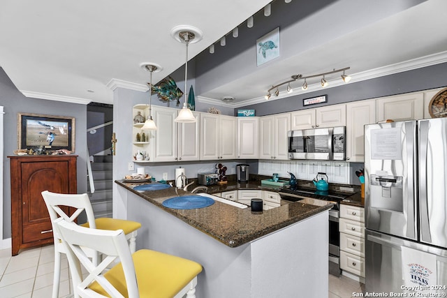 kitchen with a kitchen bar, appliances with stainless steel finishes, crown molding, light tile patterned floors, and white cabinets