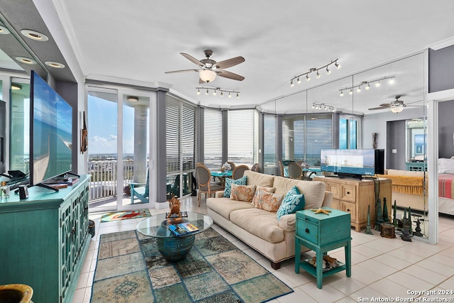 living room with ceiling fan, light tile patterned floors, and crown molding