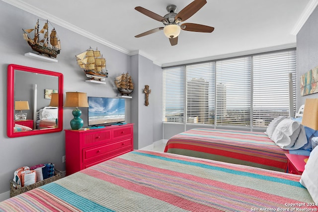 bedroom with ceiling fan, ornamental molding, and multiple windows