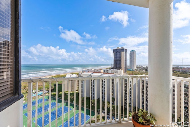 balcony with a water view and a beach view