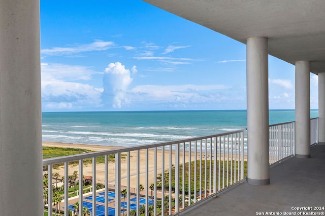 balcony with a beach view and a water view