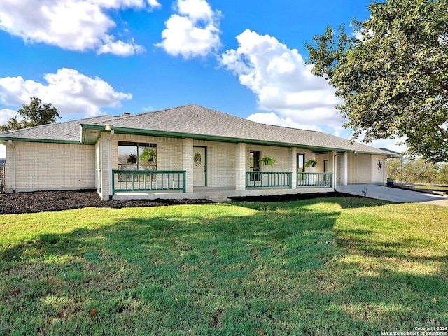 rear view of property with a lawn and covered porch