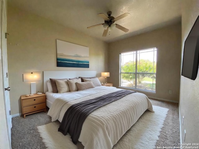 carpeted bedroom featuring ceiling fan