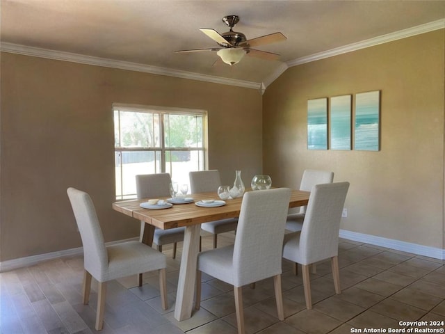 dining area with hardwood / wood-style floors, ceiling fan, lofted ceiling, and crown molding