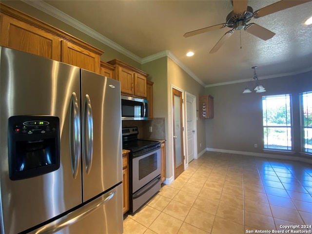 kitchen with ornamental molding, a textured ceiling, stainless steel appliances, ceiling fan, and light tile patterned floors