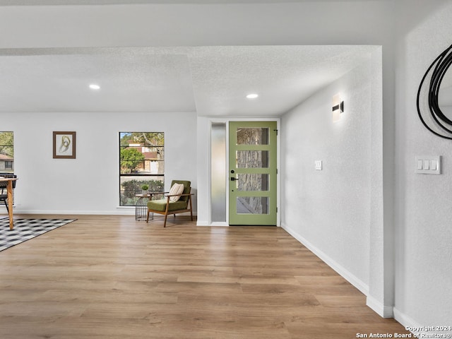 entrance foyer featuring a textured ceiling and light wood-type flooring