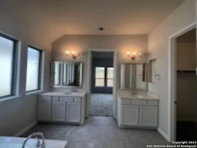 bathroom with two vanities and baseboards