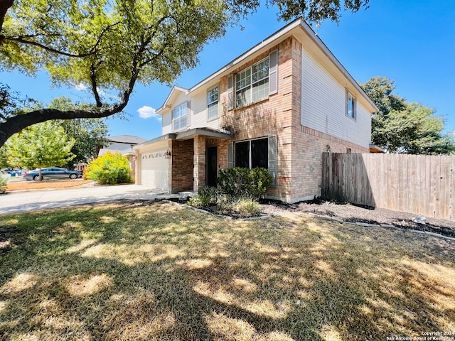 front of property with a front yard and a garage