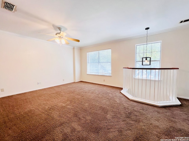 carpeted empty room with crown molding and ceiling fan