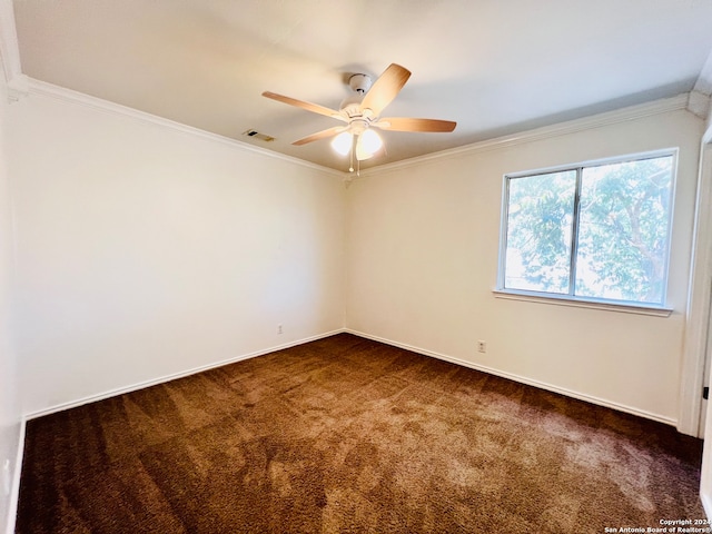 spare room with crown molding, ceiling fan, and dark carpet