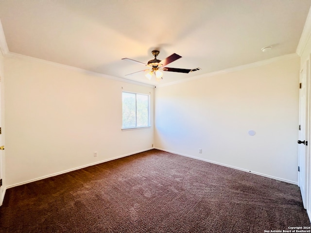 empty room with dark colored carpet, ceiling fan, and ornamental molding