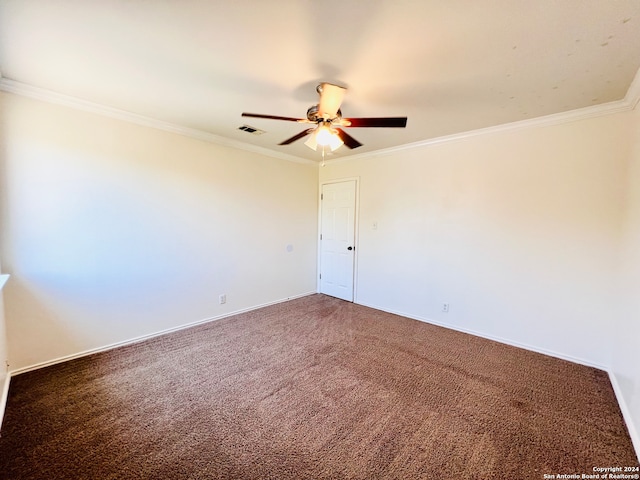 spare room featuring crown molding, ceiling fan, and dark carpet