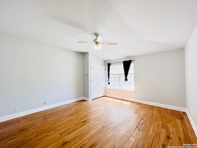 unfurnished room featuring ceiling fan, light hardwood / wood-style floors, and lofted ceiling