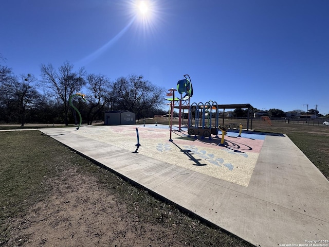 surrounding community featuring a playground and an outbuilding