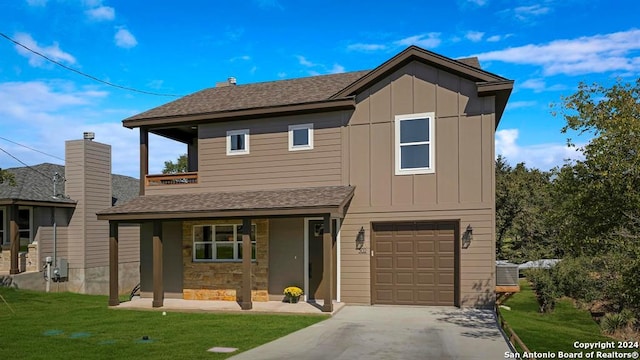 view of front of property with a porch, a garage, a front lawn, and central air condition unit