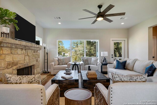 living room with ceiling fan and light wood-type flooring