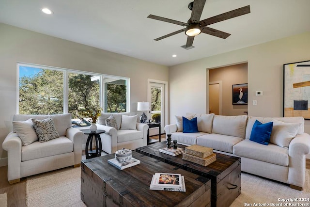 living room with ceiling fan and light wood-type flooring