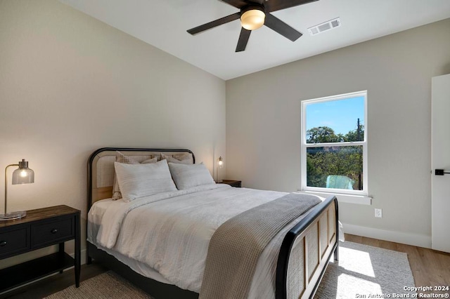 bedroom with hardwood / wood-style floors and ceiling fan