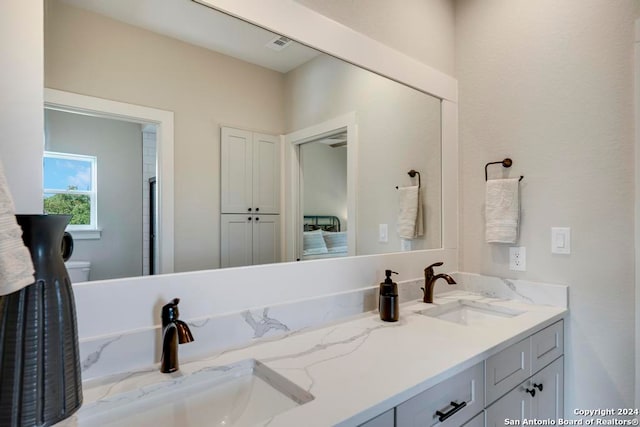 bathroom featuring vanity and toilet