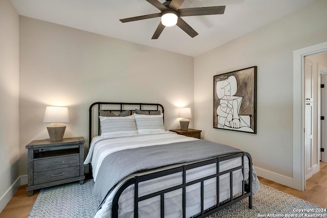 bedroom with ceiling fan and light wood-type flooring