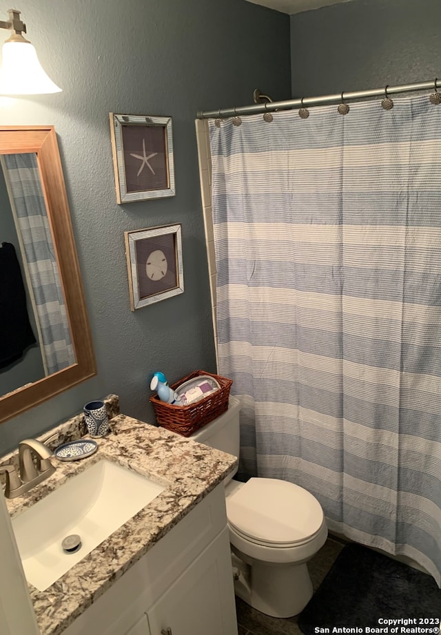 bathroom featuring vanity and toilet