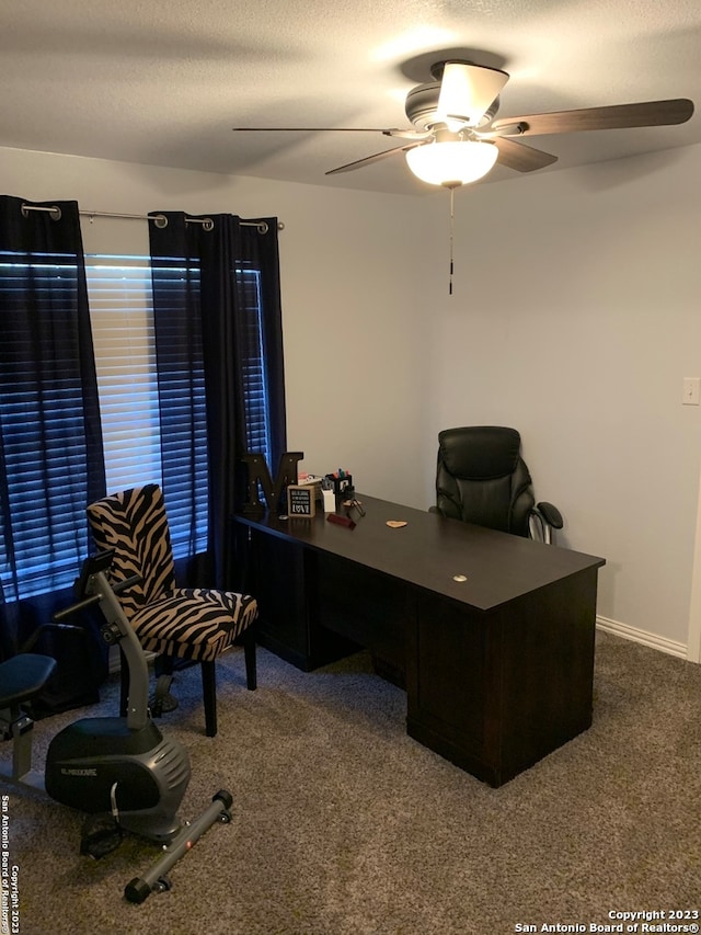 office area with carpet, a textured ceiling, and ceiling fan