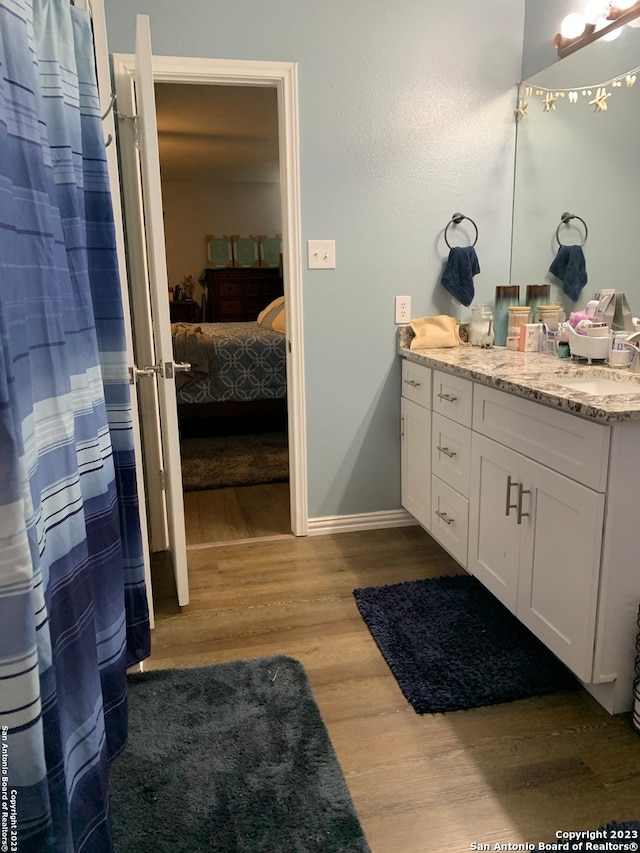 bathroom featuring vanity and hardwood / wood-style flooring